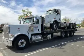 Truck hauling another truck on a flatbed